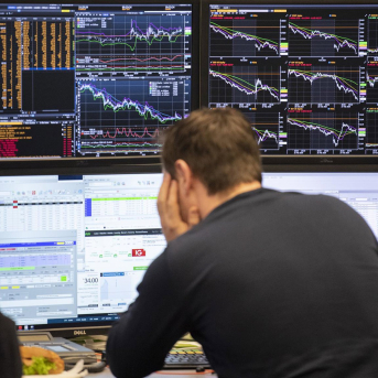 28 February 2020, Hessen, Frankfurt_Main: An exchange trader looks at his monitors at the Frankfurt Stock Exchange. Boris Roessler/dpa