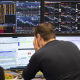 28 February 2020, Hessen, Frankfurt_Main: An exchange trader looks at his monitors at the Frankfurt Stock Exchange. Boris Roessler/dpa