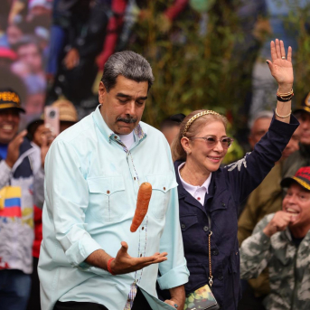 10 December 2025, Venezuela, Caracas: Venezuelan President Nicolas Maduro plays with a carrot next to his wife Cilia Flores (R) Photo: Jesus Vargas/dpa Jesus Vargas/dpa 10 December 2025, Venezuela, Caracas: Venezuelan President Nicolas Maduro plays with a carrot next to his wife Cilia Flores (R) Photo: Jesus Vargas/dpa Jesus Vargas/dpa
