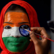 25 January 2019, India, Chennai: A college student gets her face painted in the colours of the Indian Flag ahead of the Republic Day celebrations. Photo: R Gnanasasthaa/PTI/dpa R Gnanasasthaa/PTI/dpa
