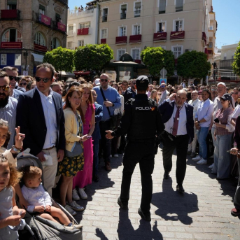 Un policía habla con un miembro de la Hermandad del Amor tras el incendio de la calle Cuna JOAQUÍN CORCHERO - EUROPA PRESS