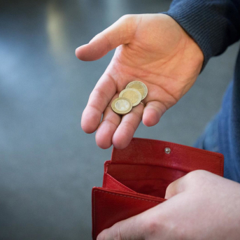 FILED - 31 January 2017, North Rhine-Westphalia, Paderborn: A person takes out coins worth five euros from a wallet. Euro zone inflation hit another record high of 9.1\% in August. Photo: Friso Gentsch/dpa Friso Gentsch/dpa