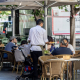Un camarero atendiendo la terraza de un bar en la temporada de verano Ricardo Rubio - Europa Press
