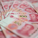 FILED - 12 December 2023, China, Beijing: Several bills, each with a value of 100 Chinese Yuan, lie on a table. Photo: Johannes Neudecker/dpa Johannes Neudecker/dpa