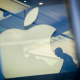 FILED - 01 November 2013, Hamburg: A man sits next to the Apple logo which is reflected on a facade of the Apple store in Hamburg.  picture alliance / dpa