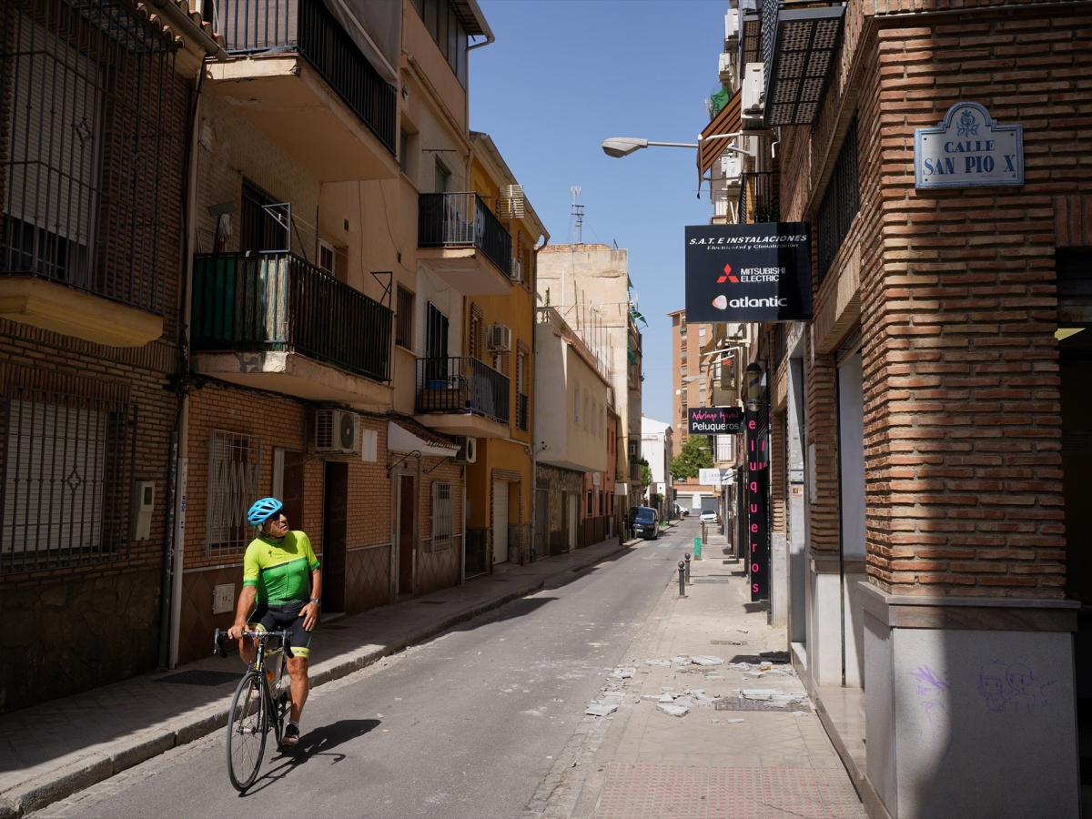 A cyclist observes the damage caused by the earthquake of August 18, 2026 in Granada