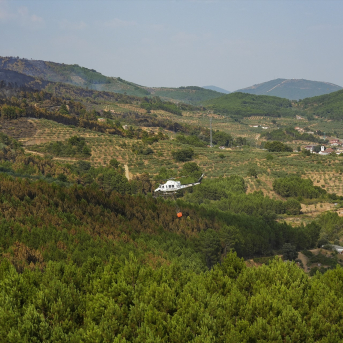 Un helicóptero colabora en las labores de extinción en Caminomorisco, Cáceres