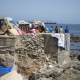 Varios inmigrantes acampados en una playa, a 31 de agosto de 2026, en Ceuta (España). Marcos Moreno - Europa Press
