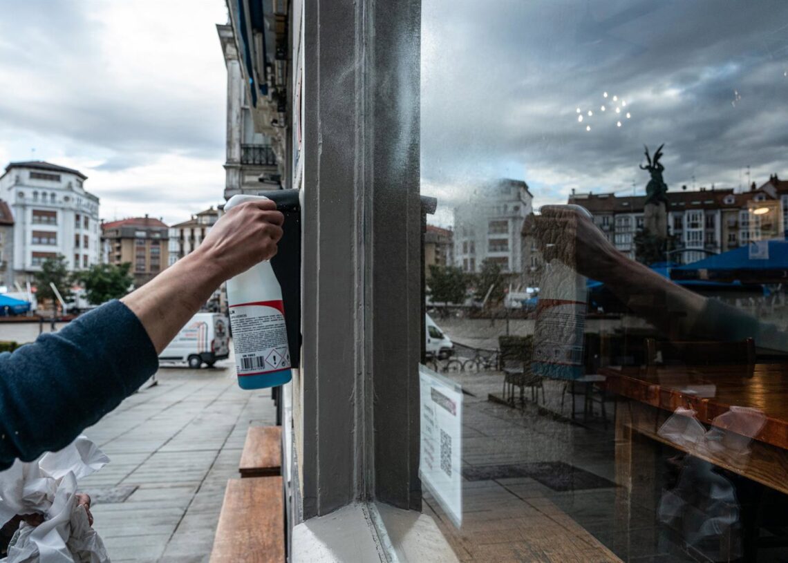 Archivo - Una camarera limpia el cristal de su cafetería Iñaki Berasaluce - Europa Press - Archivo