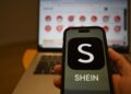 Archivo - FILED - 29 April 2024, Berlin: The Shein logo is seen on a smartphone, while the Chinese online retailer's website is open on a laptop behind it. Photo: Monika Skolimowska/dpaMonika Skolimowska/dpa - Archivo