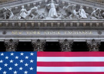 Archivo - 07 July 2025, US, New York: A US flag hangs on the facade of the New York Stock Exchange on Wall Street in Manhattan's financial district. Photo: Sven Hoppe/dpaSven Hoppe/dpa - Archivo